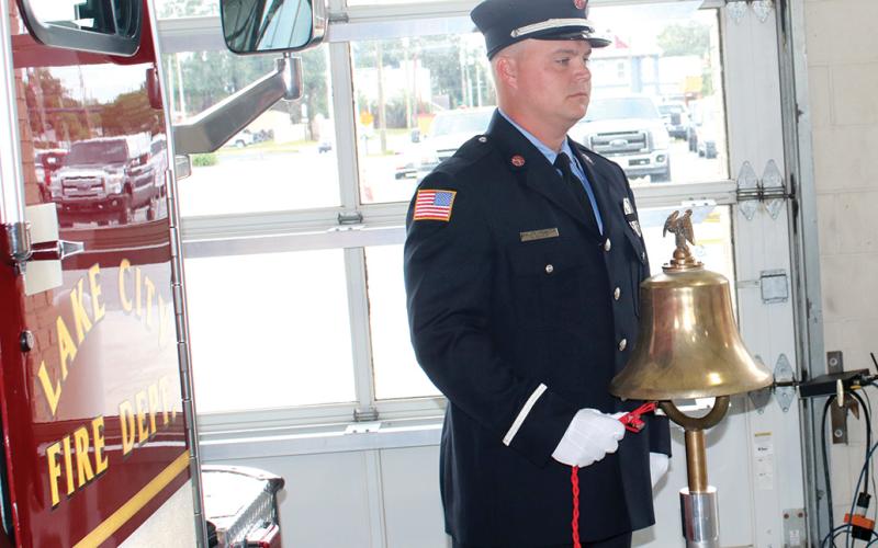A Lake City firefighter rings a bell commemorating the times that planes struck the Twin Towers and Pentagon on Sept. 11, 2001, during last year’s Patriot Day ceremony. (FILE)