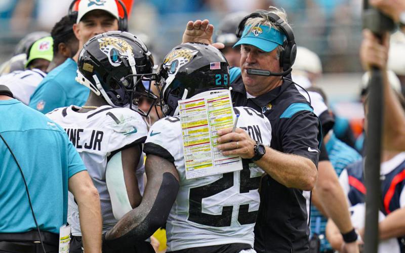 Jacksonville Jaguars running back James Robinson celebrates with head coach Doug Pederson after a touchdown against the Indianapolis Colts on Sept. 18 in Jacksonville. (JOHN RAOUX/Associated Press)