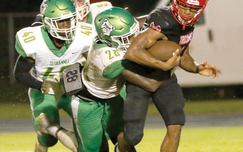 Suwannee defensive lineman Robert Robinson wraps up Hamilton County quarterback Chance Cherry last Friday. (JAMIE WACHTER/Lake City Reporter)