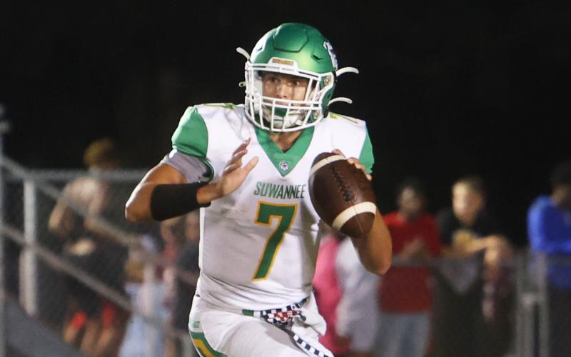 Suwannee quarterback Bronsen Tillotson rolls out to pass against North Marion on Sept. 23. (PAUL BUCHANAN/Special to the Reporter)