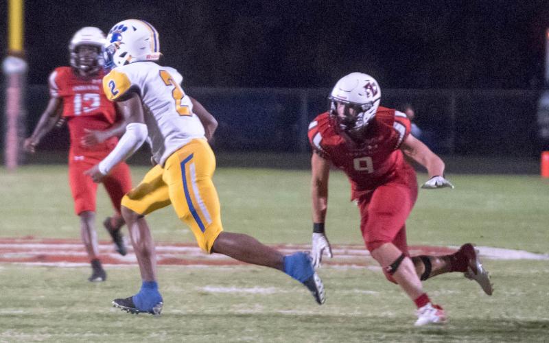 Fort White defensive end Avery Giddens heads in to tackle to Newberry running back Kaleb Woods on Friday night. (CHRISTINA FEAGIN/Special to the Reporter)