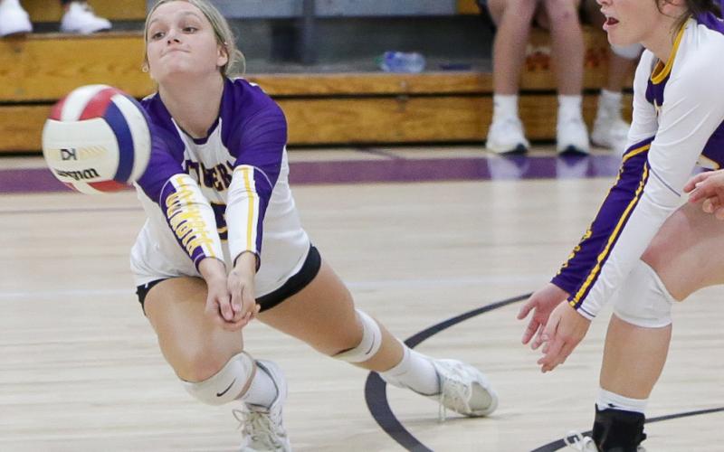Columbia’s Madison Glenn dives for the ball while Savannah Bailey looks on during Thursday’s match against Dixie County. (BRENT KUYKENDALL/Lake City Reporter)