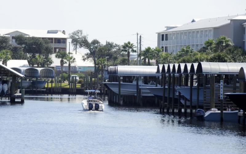 A boat cruises through a marina in rebuilt Mexico Beach on Oct. 11. Destroyed by Hurricane Michael, the Florida Panhandle community is still rebuilding four years later. (JAY REEVES/Associated Press)