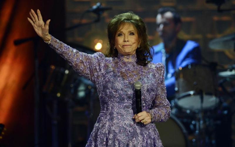 Loretta Lynn waves to the crowd after performing during the Americana Music Honors and Awards show Sept. 17, 2014. She died Tuesday at her home. She was 90. (MARK ZALESKI/Associated Press)