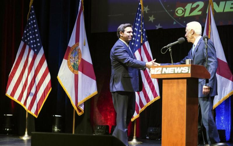 Florida’s Republican Gov. Ron DeSantis (left) and Democratic opponent Charlie Crist take to the stage for their only scheduled debate in Fort Pierce Monday. (CRYSTAL VANDER WEIT/TCPalm.com via AP)