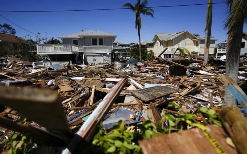 A road is completely filled with a tall pile of debris from destroyed beachfront homes and businesses, two days after the passage of Hurricane Ian, in Fort Myers Beach on Friday. (REBECCA BLACKWELL/Associated Press)