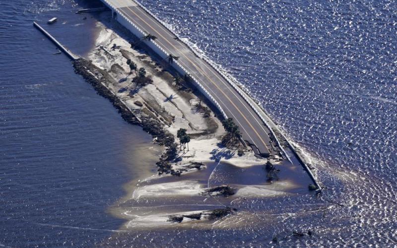 In this aerial photo made in a flight provided by mediccorps.org, damage from Hurricane Ian is seen on the causeway leading to Sanibel Island from Fort Myers on Sept. 30. (GERALD HERBERT/AP File)