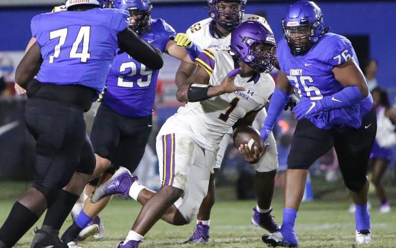 Columbia quarterback Tyler Jefferson scrambles for yardage as Trinity Christian defensive lineman Nick Williams gives chase on Sept. 23. (BRENT KUYKENDALL/Lake City Reporter)