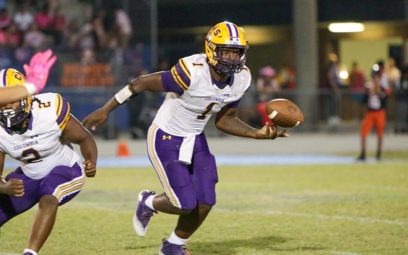 Columbia quarterback Tyler Jefferson flips the ball to a teammate during Friday’s game against Orange Park. (BRENT KUYKENDALL/Lake City Reporter)