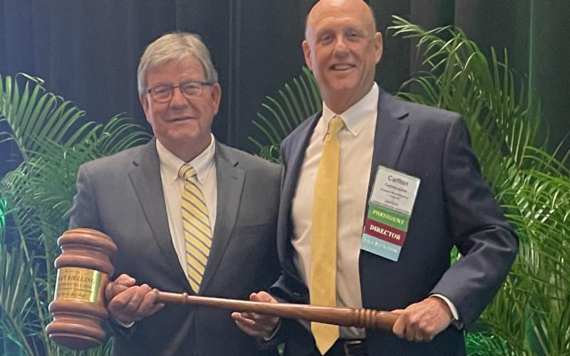 Jimmy Bielling (left) accepts the Florida Forestry Association’s presidential gavel from Carlton Jones. (COURTESY)