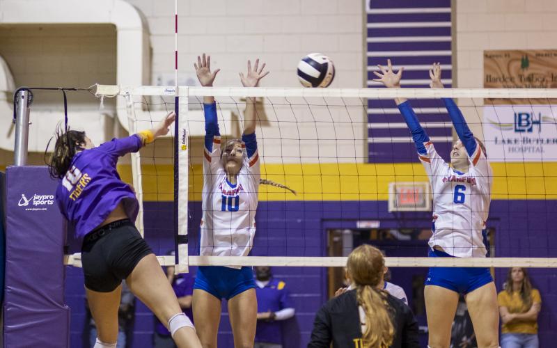 Union County’s Jaycee Davis fires a shot over the net between Branford’s Kayley Johnson (10) and Madyson Sikes (6) during Friday’s Region 3-1A semifinal. (JACK HOWDESHELL/Special to the Reporter)