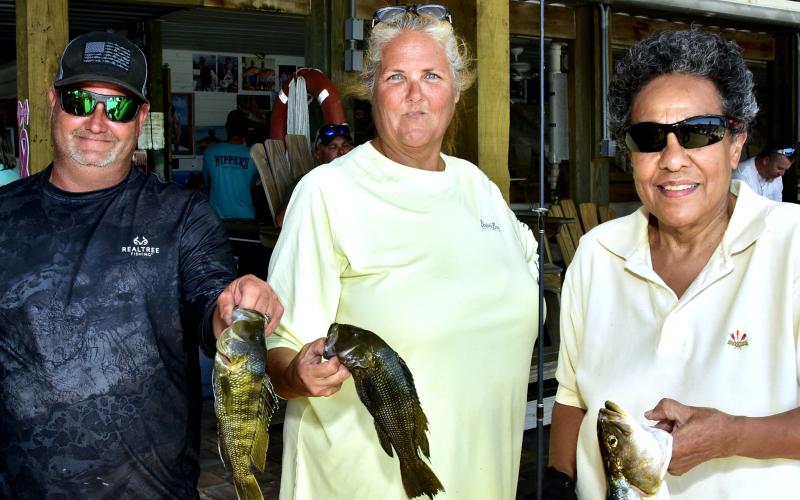 A trio of fishers display their catches at the eighth annual Hooked on Heroes fishing event. (ROB WOLFE/Special to the Reporter)