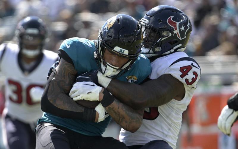 Jacksonville Jaguars tight end Evan Engram is tackled by Houston Texans linebacker Neville Hewitt on Oct. 9 in Jacksonville. (PHELAN M. EBENHACK/Associated Press)