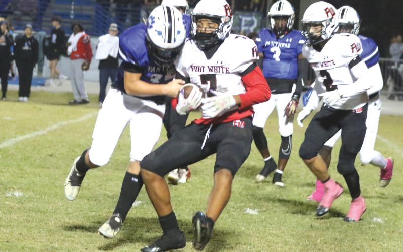 Fort White defensive back Tafari Moe runs after an interception against Ridgeview last Friday. (MORGAN MCMULLEN/Lake City Reporter)