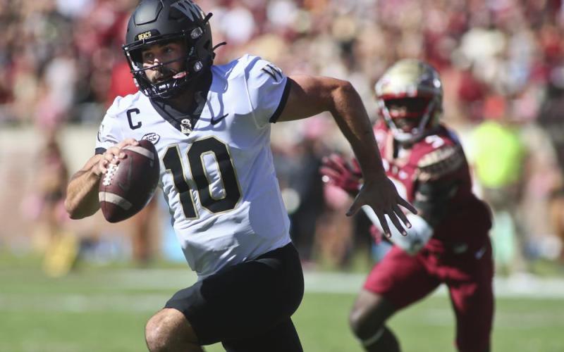 Wake Forest quarterback Sam Hartman runs out of the pocket against Florida State on Saturday in Tallahassee. (PHIL SEARS/Associated Press)