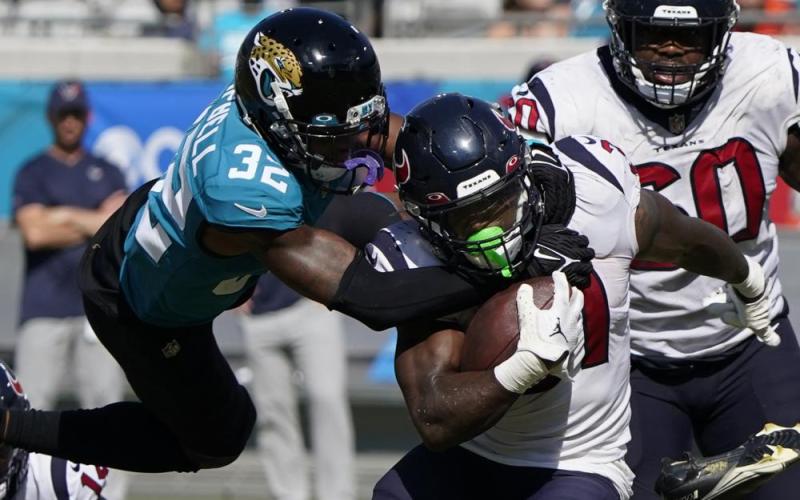 Jaguars cornerback Tyson Campbell tackles Houston Texans running back Dameon Pierce during Sunday's game in Jacksonville. (JOHN RAOUX/Associated Press)
