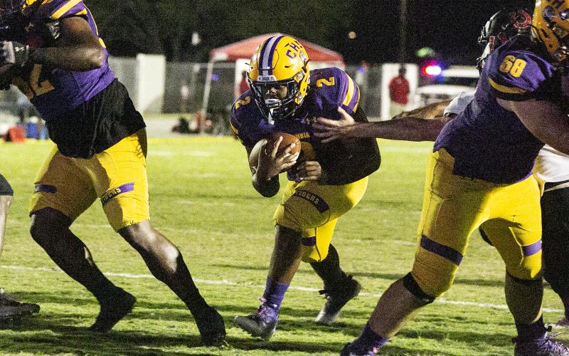 Columbia running back Tony Fulton hits the hole against Middleburg last Friday. (JEN CHASTEEN/Special to the Reporter)