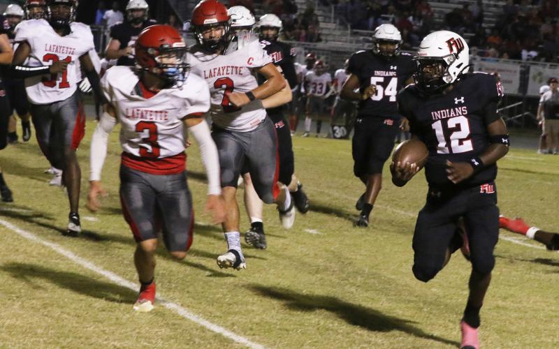 Fort White running back Najeeb Smith eyes Lafayette safety Baylor Johnson on a run Friday night at Arrowhead Stadium. (MORGAN MCMULLEN/Lake City Reporter)