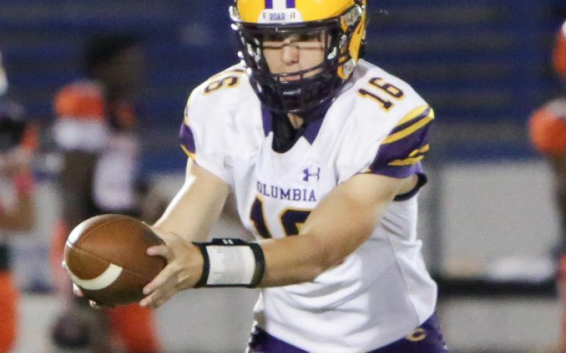 Columbia quarterback Evan Umstead turns to hand the ball off during Friday’s game against Orange Park. (BRENT KUYKENDALL/Lake City Reporter)