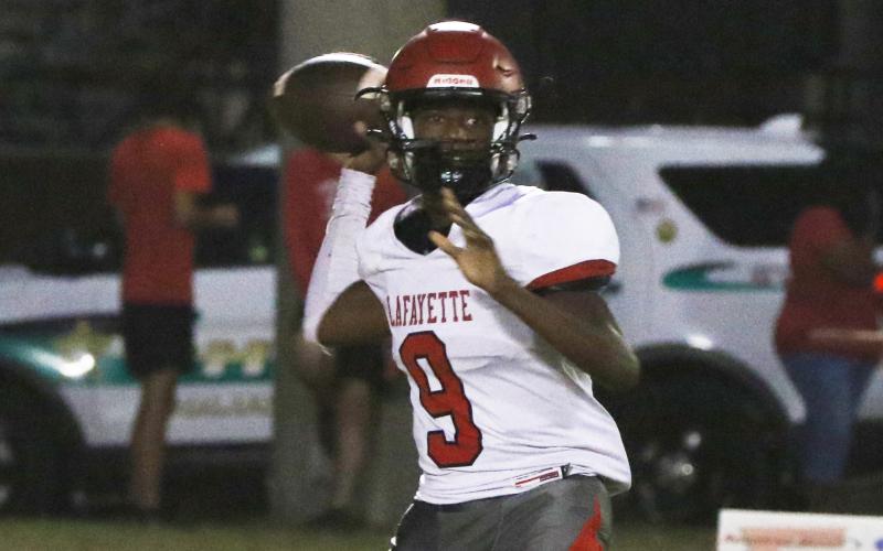 Lafayette quarterback Tywan Williamson sets to throw a pass against Fort White last Friday. (MORGAN MCMULLEN/Lake City Reporter)