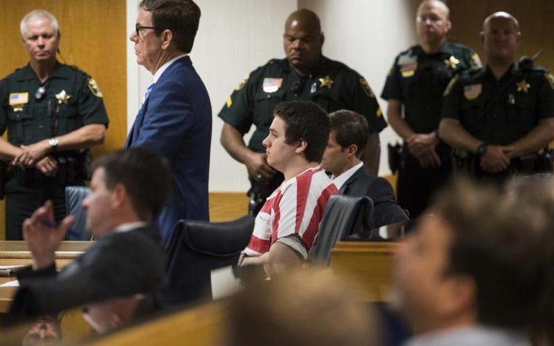 Austin Harrouff, center, wearing stripes, accused of brutally killing a Tequesta couple in 2016, appears Aug. 2, 2019, at the Martin County Courthouse in Stuart. (AP File)