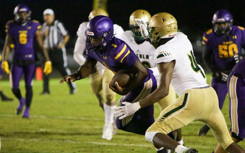 Columbia quarterback Tyler Jefferson scrambles for yardage against Lincoln in the Region 1-3S quarterfinals last Friday. (BRENT KUYKENDALL/Lake City Reporter)
