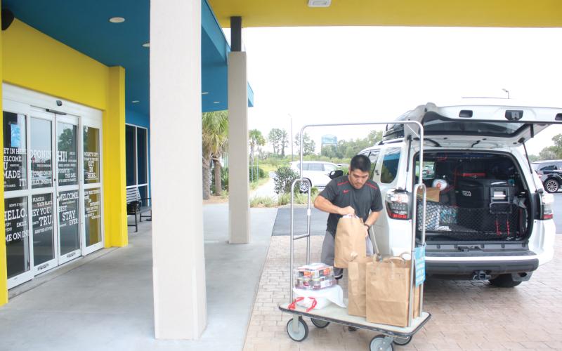 Long Vu, from Tampa, unpacks his vehicle at the Tru by Hilton hotel in Lake City in September. Columbia County’s Tourism Development Council said the county had collected over $2 million in bed taxes for the first time ever. (FILE)