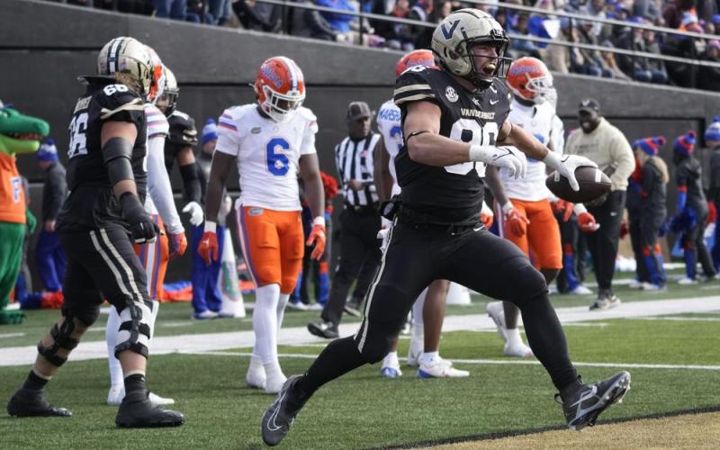 Vanderbilt running back Ray Davis (2) is driven out of bounds by Florida safety Trey Dean III (0) on Saturday in Nashville, Tenn. (MARK HUMPHREY/Associated Press)