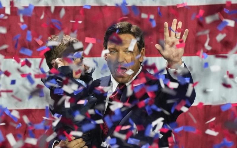 Incumbent Florida Republican Gov. Ron DeSantis holds his son Mason as he celebrates winning reelection, at an election night party Tuesday in Tampa. (REBECCA BLACKWELL/Associated Press)
