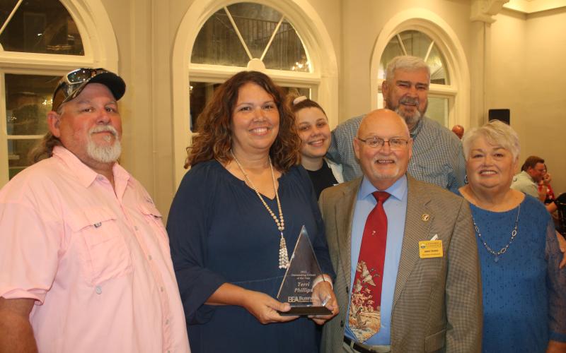 Terri Phillips, (second from left) stands with her husband Bobby Phillips (front row from from left) Jimmy Sparks and Darlene Smith and (back row, from left) Bree Faulkner and James Smith after she was selected as the 2022 Lake City-Columbia County Chamber of Commerce Outstanding Citizen of the Year during the organization’s annual Business Excellence Awards Ceremony on Monday night. (TONY BRITT/Lake City Reporter)