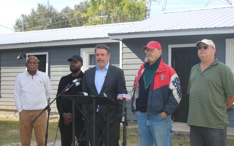James Hodges (second from right) listens as his attorney John M. Phillips speaks at Thursday’s press conference. (TONY BRITT/Lake City Reporter)