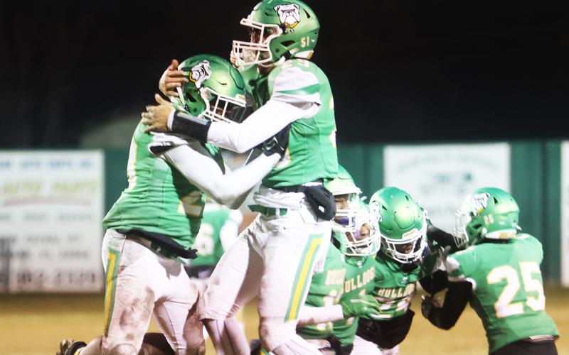 Suwannee’s Robert Robinson (left) and Blake Wynn (right) celebrate after Robinson recovered a fumble against West Florida during the Region 1-2S semifinals on Friday. (PAUL BUCHANAN/Special to the Reporter)