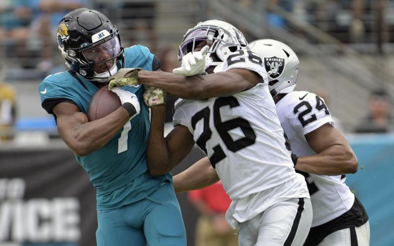 Jacksonville Jaguars wide receiver Zay Jones is stopped by Las Vegas Raiders cornerback Rock Ya-Sin during Sunday's in Jacksonville. (PHELAN M. EBENHACK/Associated Pres)