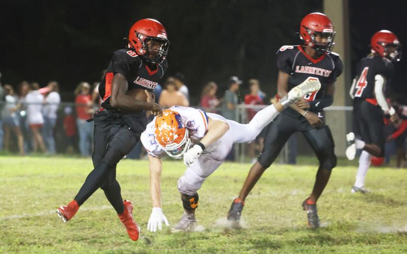 Lafayette running back Johntavious Cook runs past Branford defensive lineman Cole Certain on Oct. 17. (PAUL BUCHANAN/Special to the Reporter)