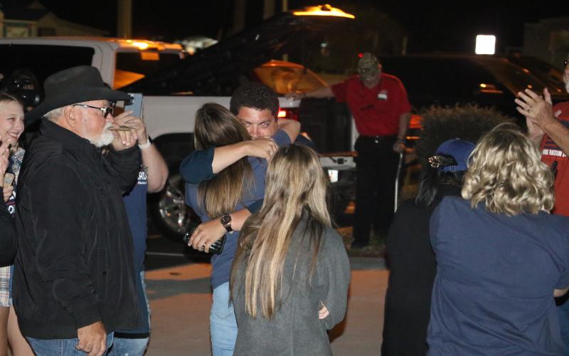 Hunter Peeler gets a hug from a supporter outside the Columbia County Supervisor of Elections Office on Tuesday night after winning the District 5 seat on the Columbia County School Board. (MORGAN MCMULLEN/Lake City Reporter)