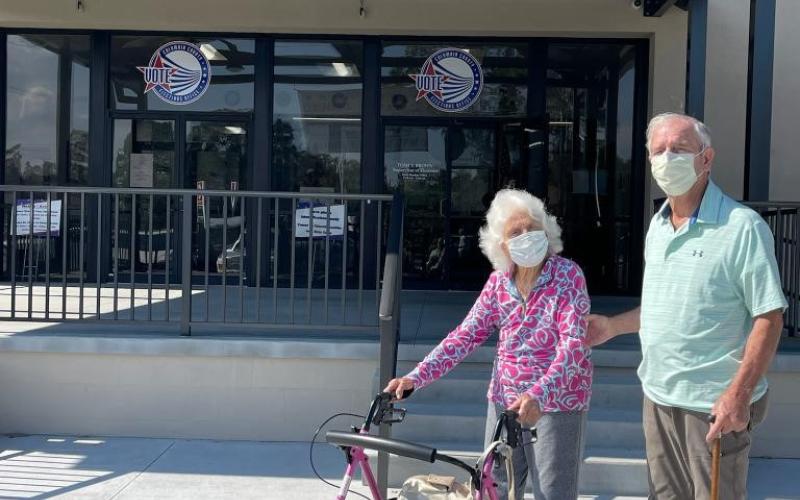 Helena Powers (left), a 106-year-old voter, makes time to cast her ballot alongside her son, Frank Powers (82). (COURTESY)