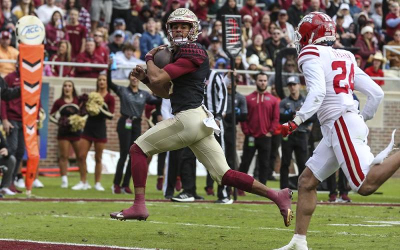 Florida State quarterback Jordan Travis runs for a touchdown against Louisiana on Nov. 19 in Tallahassee. (GARY MCCULLOUGH/Associated Press)
