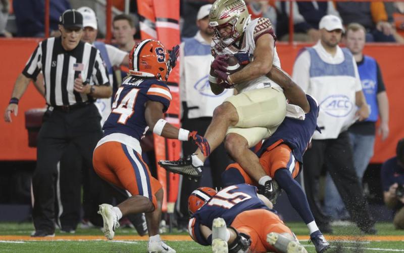 Syracuse defensive back Alijah Clark, defensive back Jeremiah Wilson (24), and linebacker Derek McDonald (15) tackle Florida State wide receiver Mycah Pittman during Saturday's game in Syracuse, N.Y. (JOSHUA BESSEX/Associated Press)