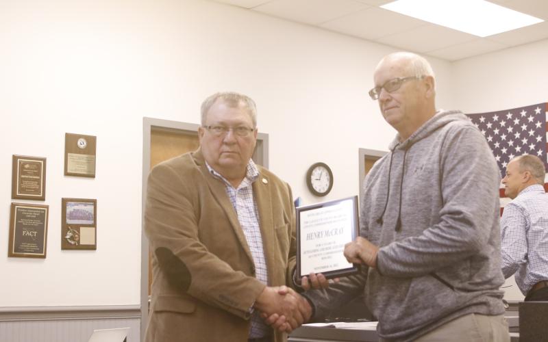 Henry McCray (right) receives a plaque for his four years of service on the Lafayette County Commission from Chairman Anthony Adams at Monday’s meeting. (JAMIE WACHTER/Lake City Reporter)