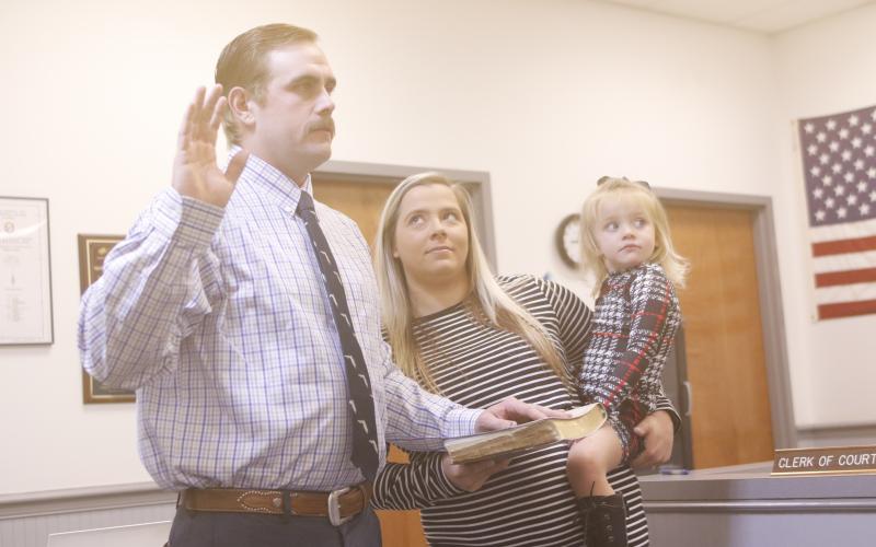 New County Commissioner Mason Byrd is sworn in Tuesday, joined by his wife, Sydney, and daughter, Aspen. (JAMIE WACHTER/Lake City Reporter)