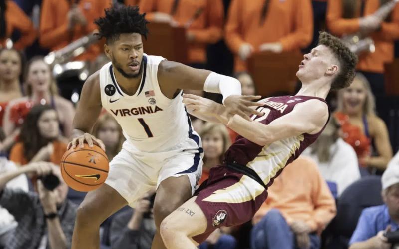 Virginia's Jayden Gardner commits a foul against Florida State’s Tom House during Saturday’s game in Charlottesville, Va. (MIKE KROPF/Associated Press)