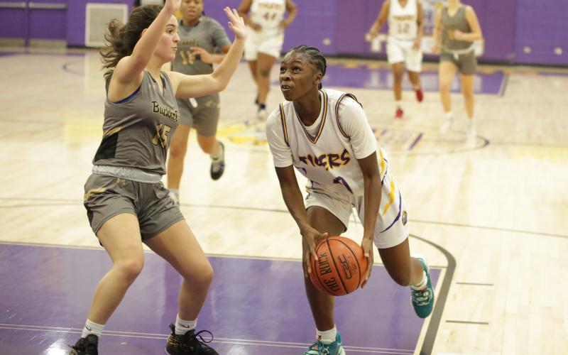 Columbia guard Ayesha Broxey drives to the basket as Buchholz guard Carly Fischer defends on Tuesday night. (BRENT KUYKENDALL/Lake City Reporter)