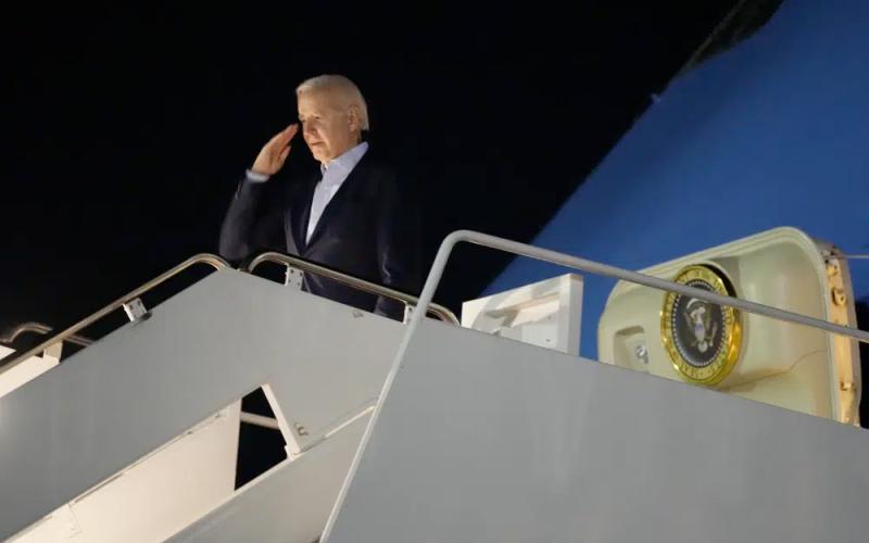 President Joe Biden salutes as he boards Air Force One at Andrews Air Force Base on Tuesday. Biden and his family are traveling to St. Croix, U.S. Virgin Islands, to celebrate New Year. (MANUEL BALCE CENETA/Associated Press)