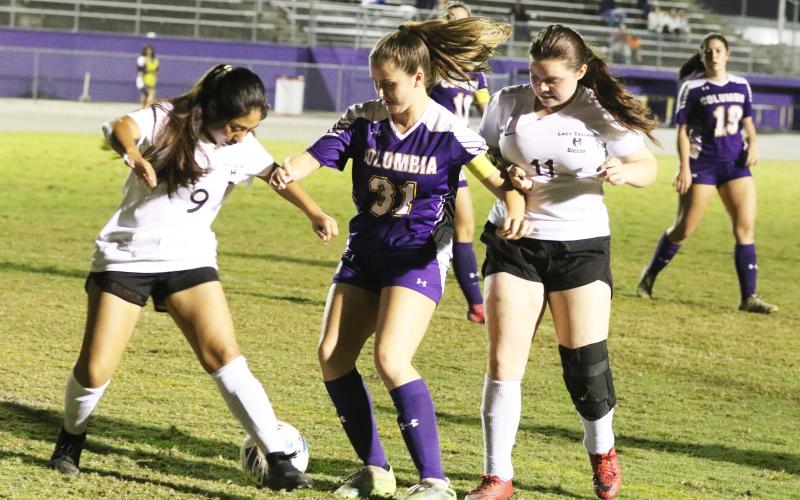 Columbia’s Sydney Rivas fights for possession of the ball with Hamilton County’s Joseline Garcia (9) and Malyiah Marcano (11) on Tuesday night. (MORGAN MCMULLEN/Lake City Reporter)