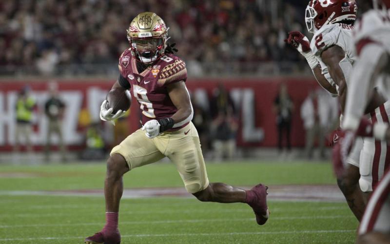 Florida State running back Treshaun Ward rushes as Oklahoma linebacker David Ugwoegbu defends during the Cheez-It Bowl on Thursday in Orlando. (PHELAN M. EBENHACK/Associated Press)