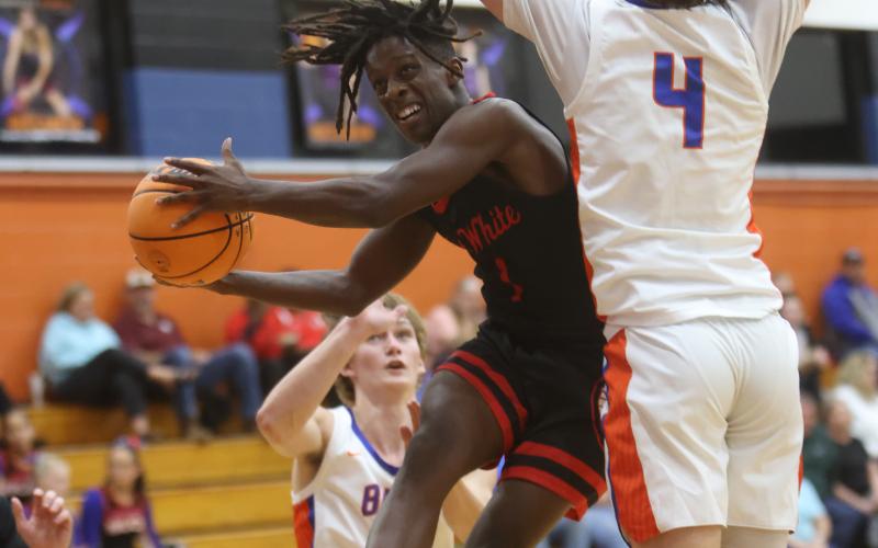 Fort White guard Najeeb Smith drives to shoot while being defend by Branford guard Camden Gaskins on Thursday night. (PAUL BUCHANAN/Special to the Reporter)