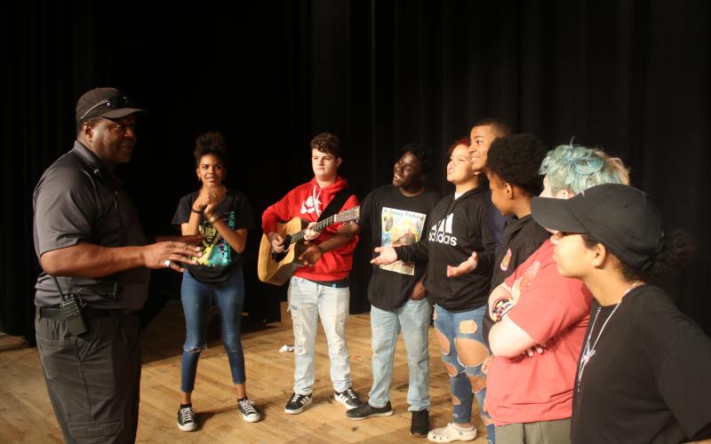 Ronnie Collins (from left), Columbia’s Top Talent competition founder and sponsor, talks to contestants Di’Amee Reese, AJ Busscher, Omarion Howard, Michelle Burch, Omarion Udell, Jacqueline Wiley, Ash Esposito and Jaleiah Burch as they prepare to compete in the first round of competition on Friday night at the Norman Choice Performing Arts Auditorium on the Columbia High School campus. (TONY BRITT/Lake City Reporter)