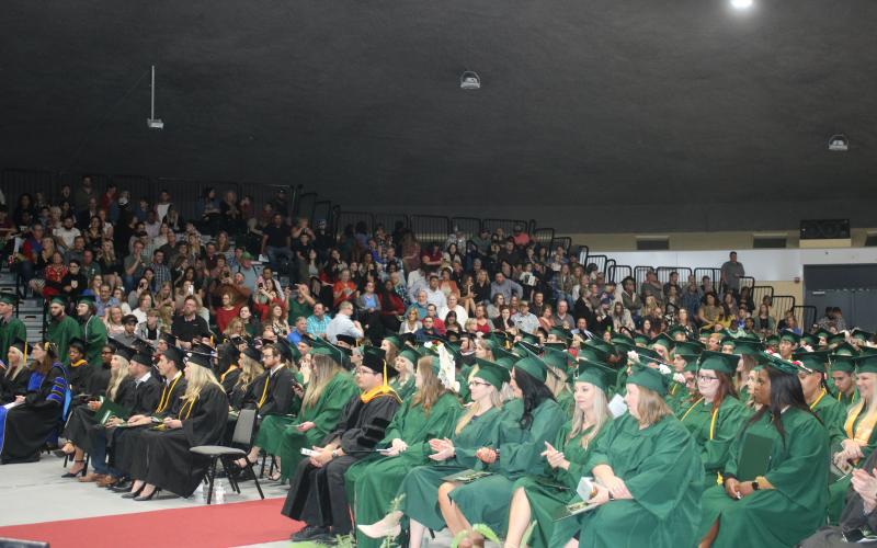 Florida Gateway College students listen during Thursday’s graduation ceremony in front of friends and family in attendance at the Howard Center. (TONY BRITT/Lake City Reporter)
