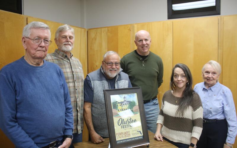 John Larner (from left) stands with members of the Blue-Grey Army Tom Coleman, Tony Buzzella, Sean McMahon, Sheila Carr (representing the Gateway Art Gallery) and Faye Bowling Warren on Tuesday night as the 44th Annual Olustee Battle Festival poster was unveiled. Larner created the painting that will be used of the event poster. (TONY BRITT/Lake City Reporter)