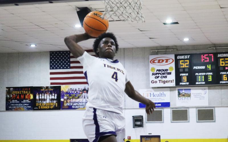 Columbia forward Ty’Jahn Wright rises for a dunk against Buchholz on Wednesday night. (JORDAN KROEGER/Lake City Reporter)